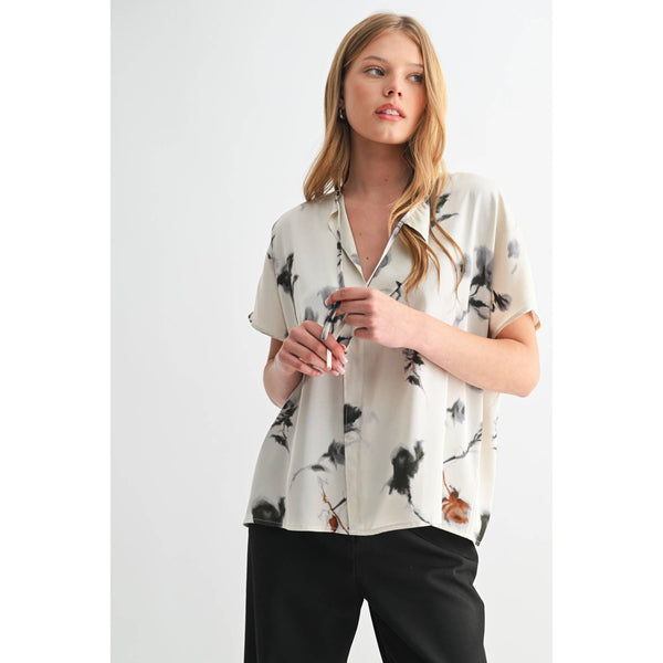 Woman wearing a floral blouse with a plain background