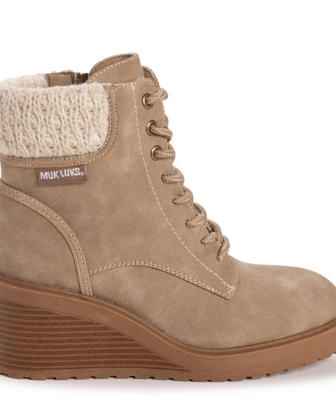 Tan ankle boot with shearling lining on a white background