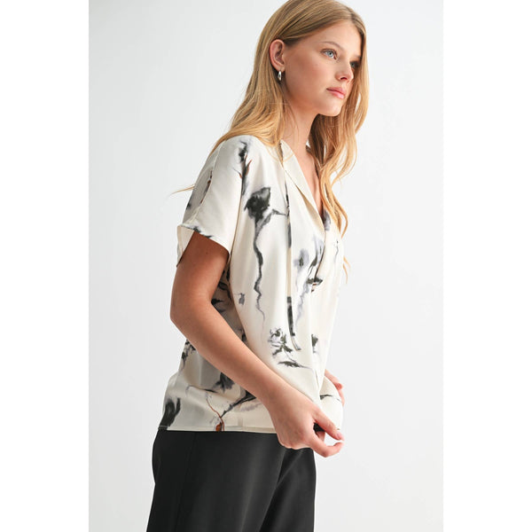 Woman wearing a floral blouse with a plain background