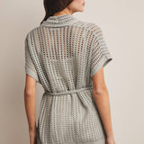 Woman wearing a Sage knit Cardigan with open knit and waist tie 