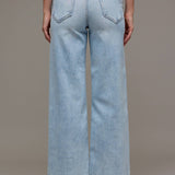Light blue wide-leg jeans worn by a person on a neutral background