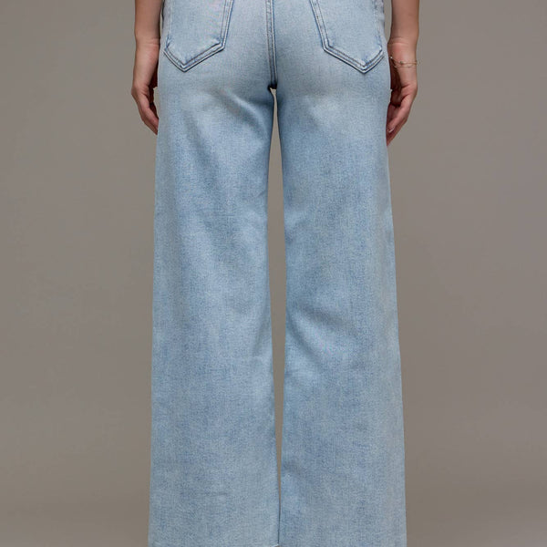 Light blue wide-leg jeans worn by a person on a neutral background