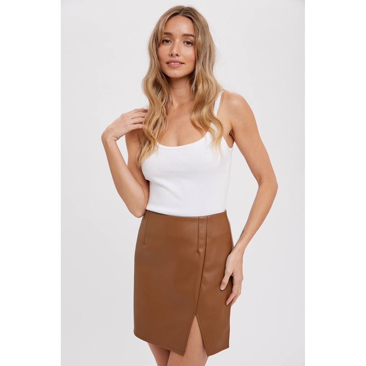 Light brown faux leather mini skirt with slit; womens clothing.