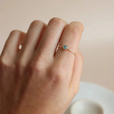 Small and elegant aquamarine ring accessory with gold band.