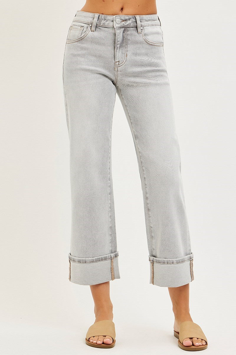 Light gray fold hem jeans worn by a person on a white background