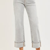 Light gray fold hem jeans worn by a person on a white background