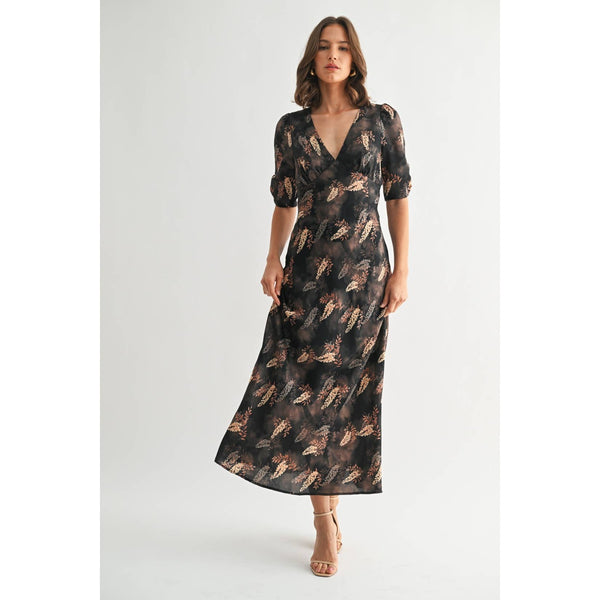 Woman wearing a patterned dress on a white background