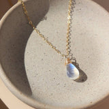 Teardrop moonstone necklace on gold chain; outfit accessory or gift. 