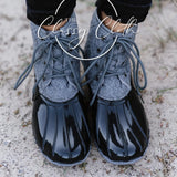 Black and grey  laced up duck boots; womens shoes. 