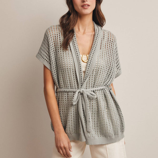 Woman wearing a Sage knit Cardigan with open knit and waist tie 