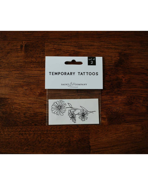 Black ink temporary Daisy tattoo for April birth month.